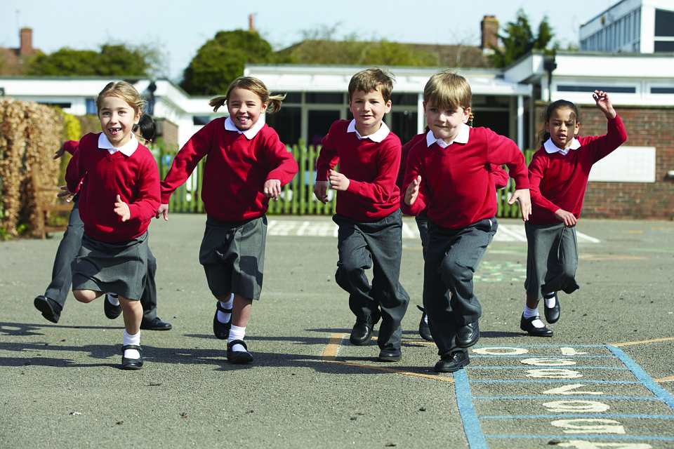students running happily in school grounds