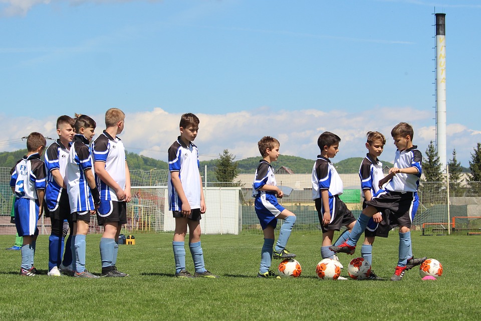 school boys gathering for a game of soccer