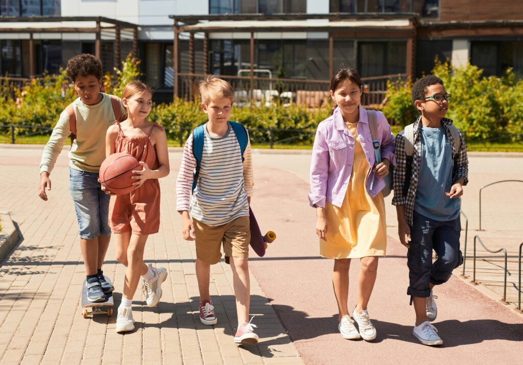 School children walking happily through school grounds